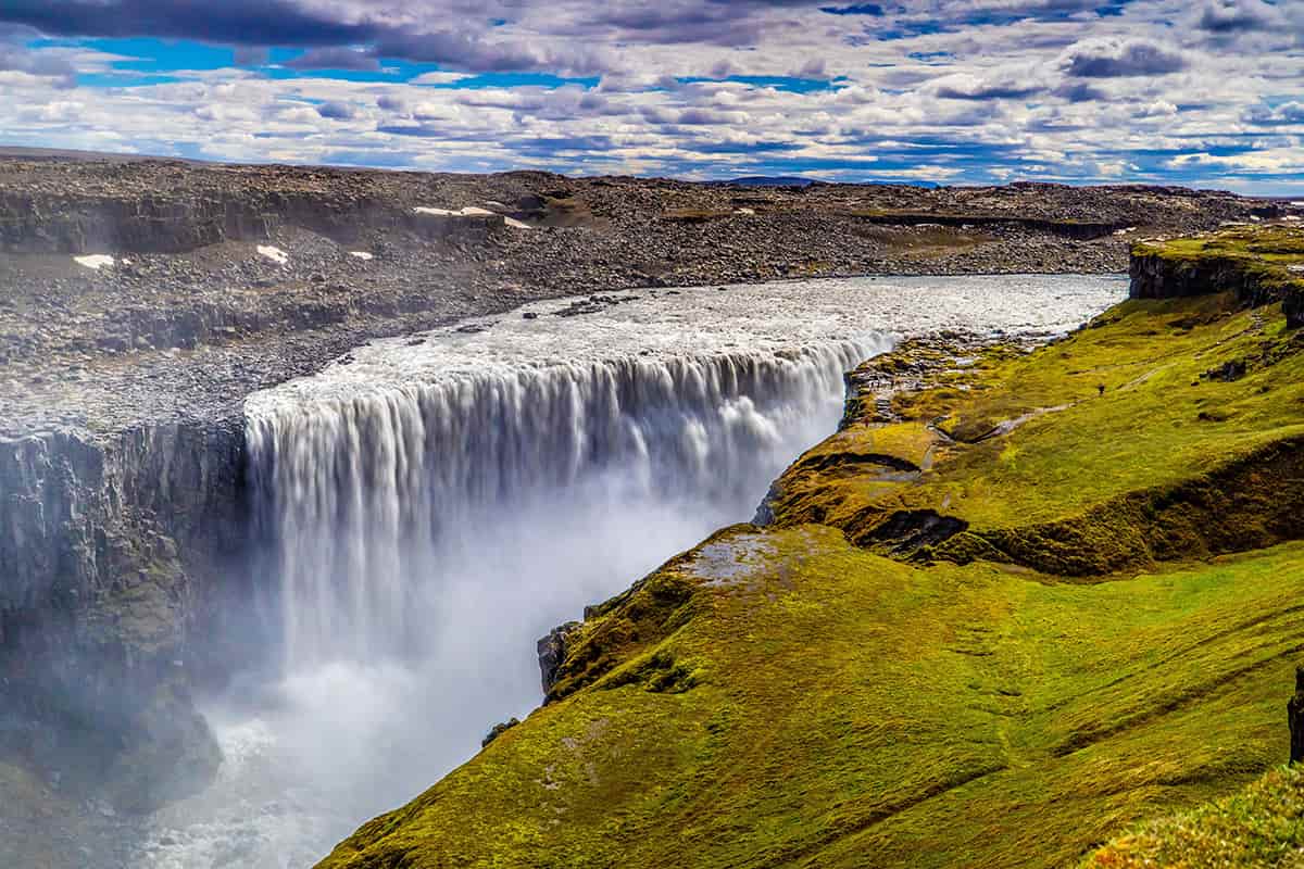 Dettifoss waterfall in North Iceland, thundering into a rocky canyon with mist rising from the powerful flow