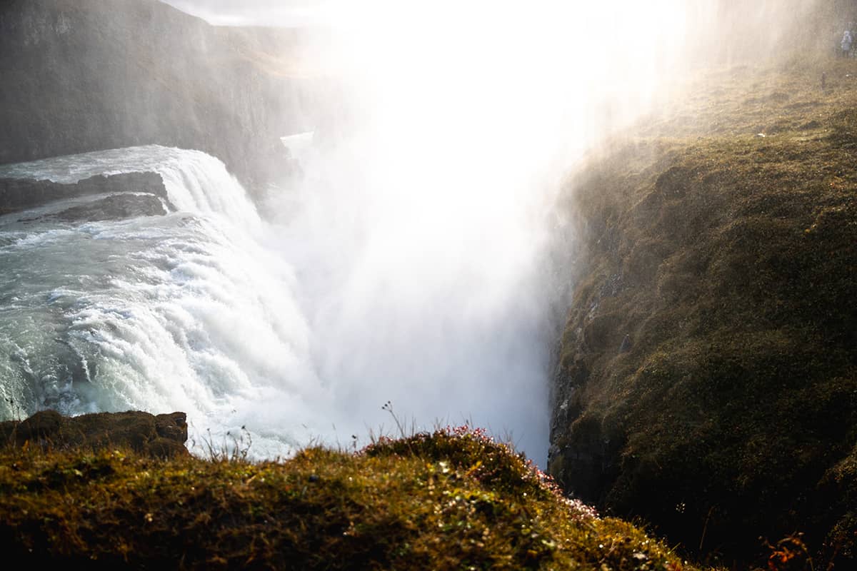 Gullfoss waterfall in Iceland with powerful cascading water plunging into a rugged canyon under a dramatic sky