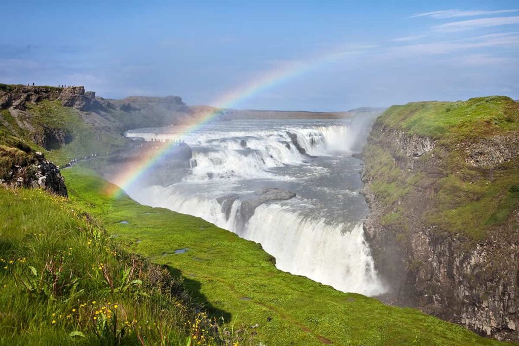 Gullfoss waterfall in Iceland with powerful cascading water plunging into a rugged canyon under a dramatic sky