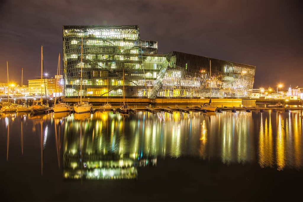 Harpa Concert Hall in Reykjavík, Iceland, with its geometric glass façade reflecting the sky