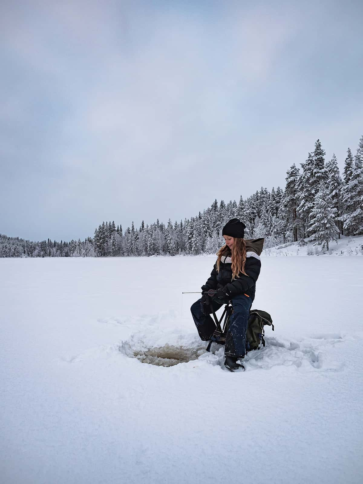 Ice fishing on a frozen lake near Kiruna