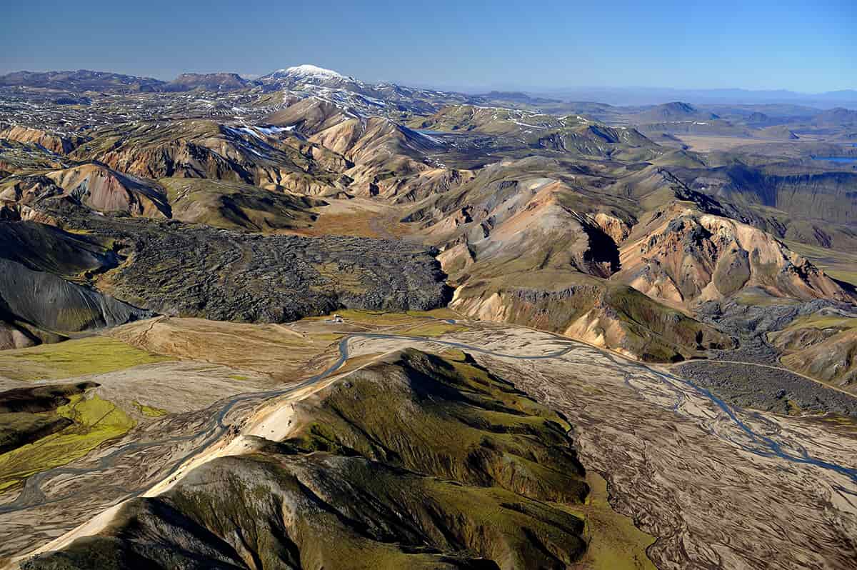 Landmannalaugar in the Icelandic highlands with colorful rhyolite mountains, lava fields, and steaming geothermal vents under a wide open sky