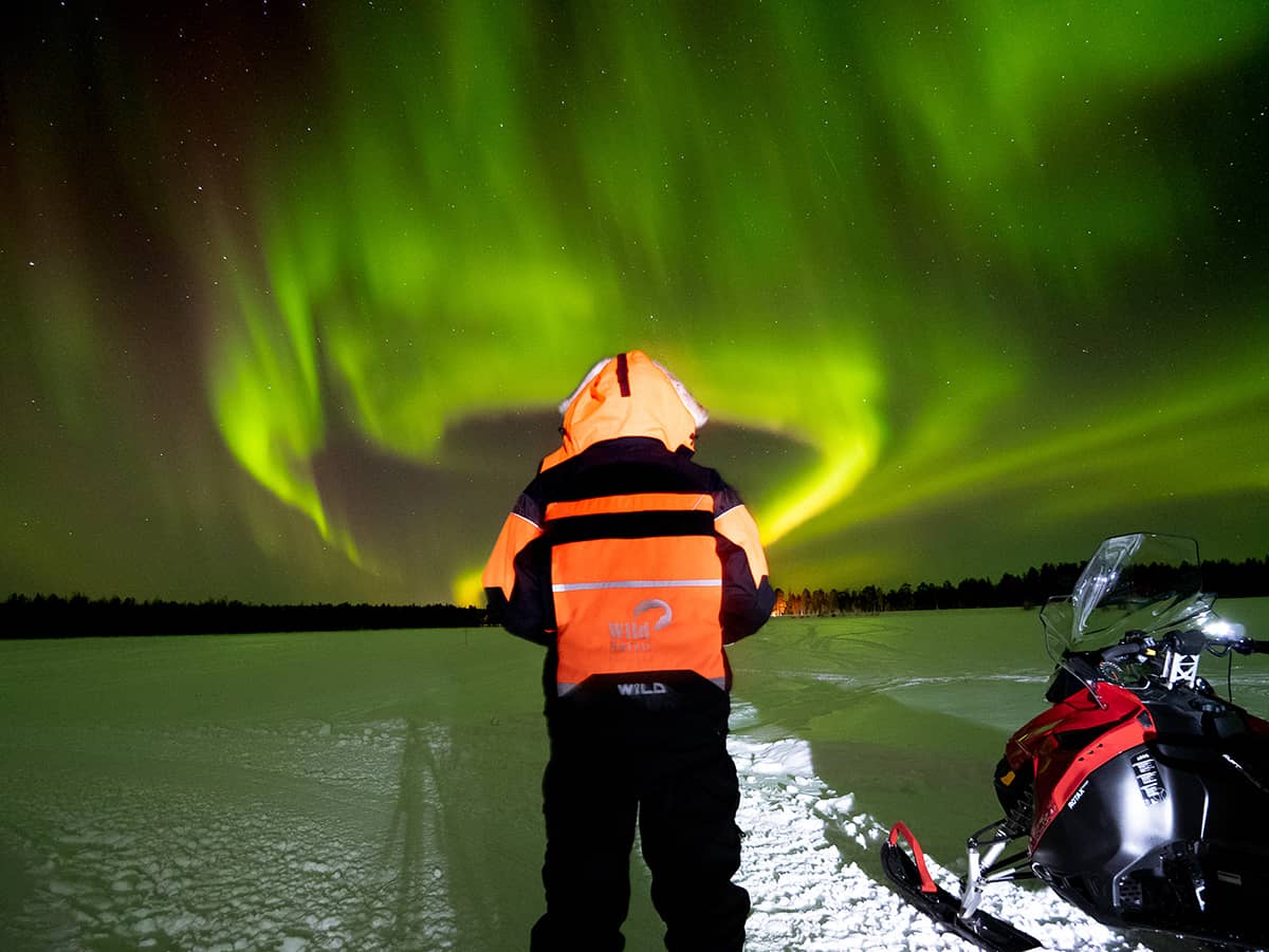 Northern lights by snowmobile in Levi