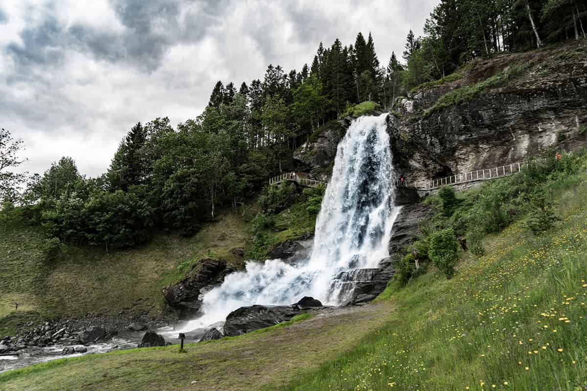 Steinsdalsfossen waterfall cascading behind a walking path near Norheimsund, Norway