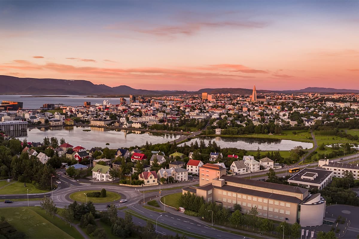 A panoramic view of Reykjavík, Iceland’s capital, with colorful rooftops, modern buildings, and mountains in the background