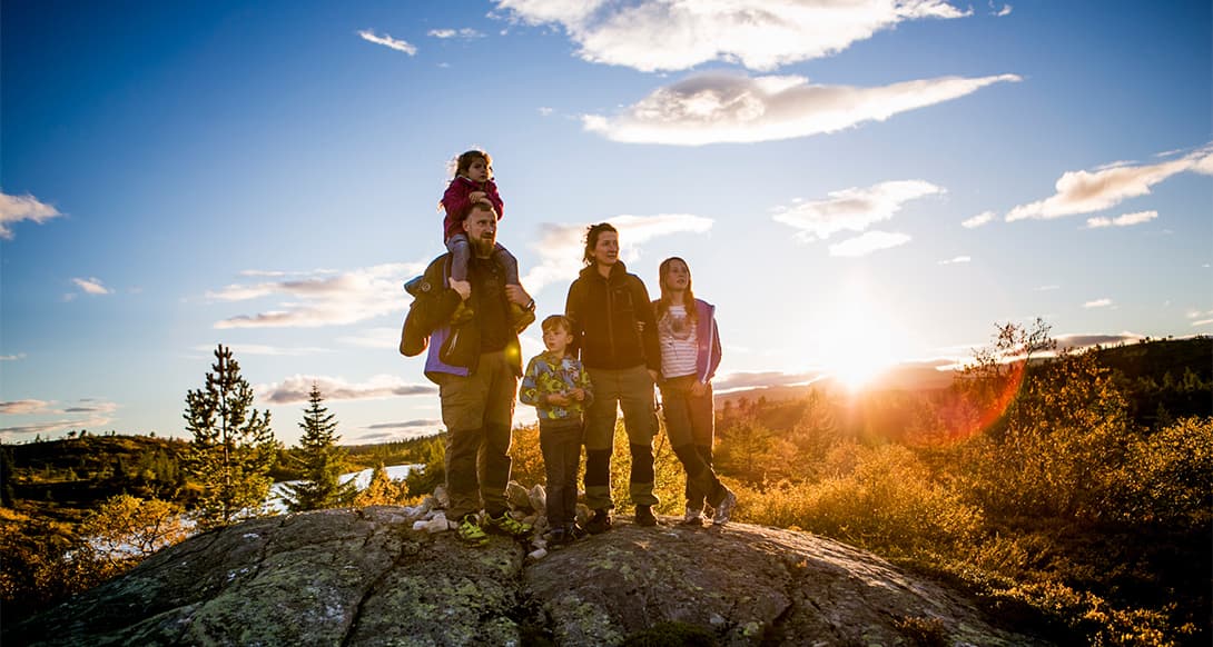 Family hiking together in Blefjell Norway surrounded by scenic mountain views and open landscape joyful outdoor nature experience