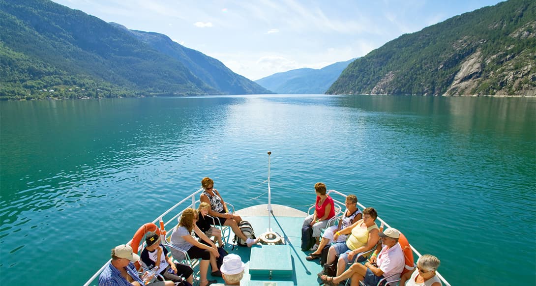 Scenic fjord cruise through Akrafjorden in western Norway with steep cliffs waterfalls and calm waters offering peaceful exploration