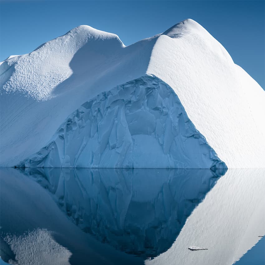 An iceberg mirroring in the perfectly still waters of the Disko Bay