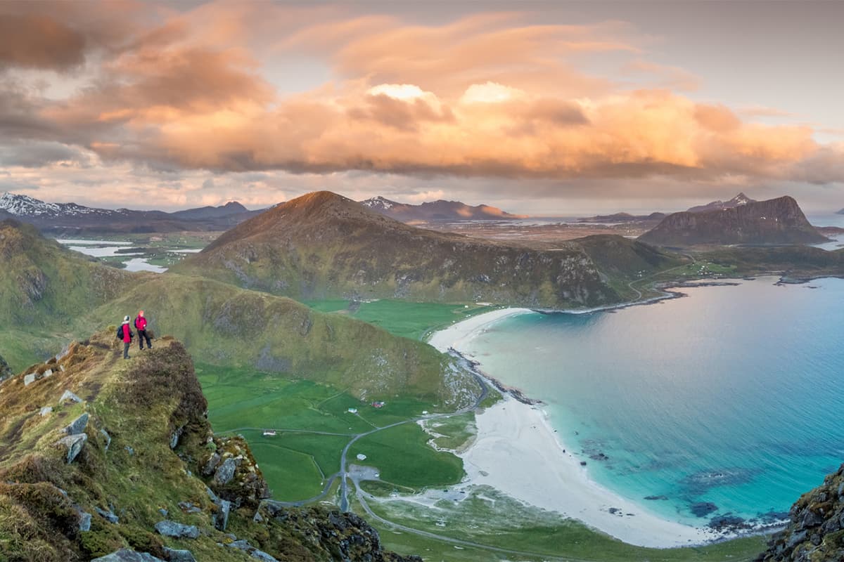 Hiking trail on Mannen Mountain in Norway with sweeping views of cliffs and fjords, offering a dramatic and adventurous alpine experience