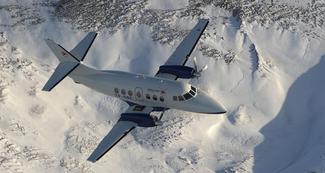 Jetstream aircraft operated by Ernir Air parked on runway in Iceland ready for regional flight under clear sky aviation and travel service