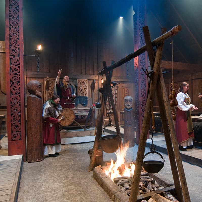 Lofotr Viking Museum in Lofoten, Norway, featuring a reconstructed longhouse and scenic surroundings that reflect Viking history and culture