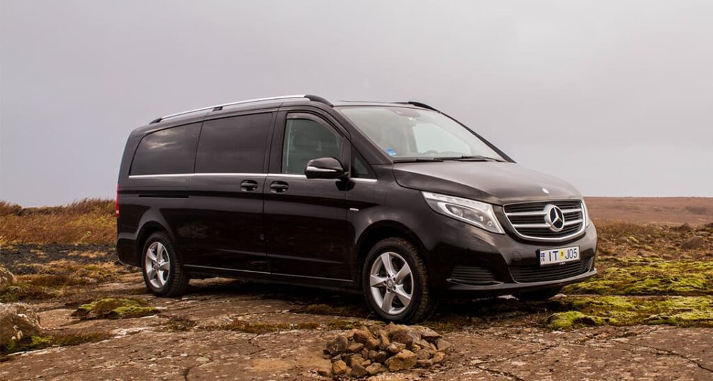 Mercedes Benz V Class parked on open road in Iceland with mountains in background highlighting comfort style and scenic travel experience