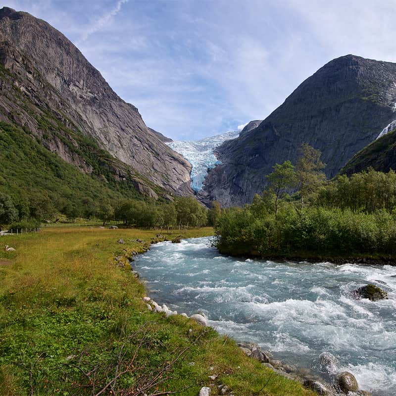 Nordfjord in Norway with calm waters, steep mountains, and scattered villages, showcasing the serene beauty of Western Norway’s fjord region