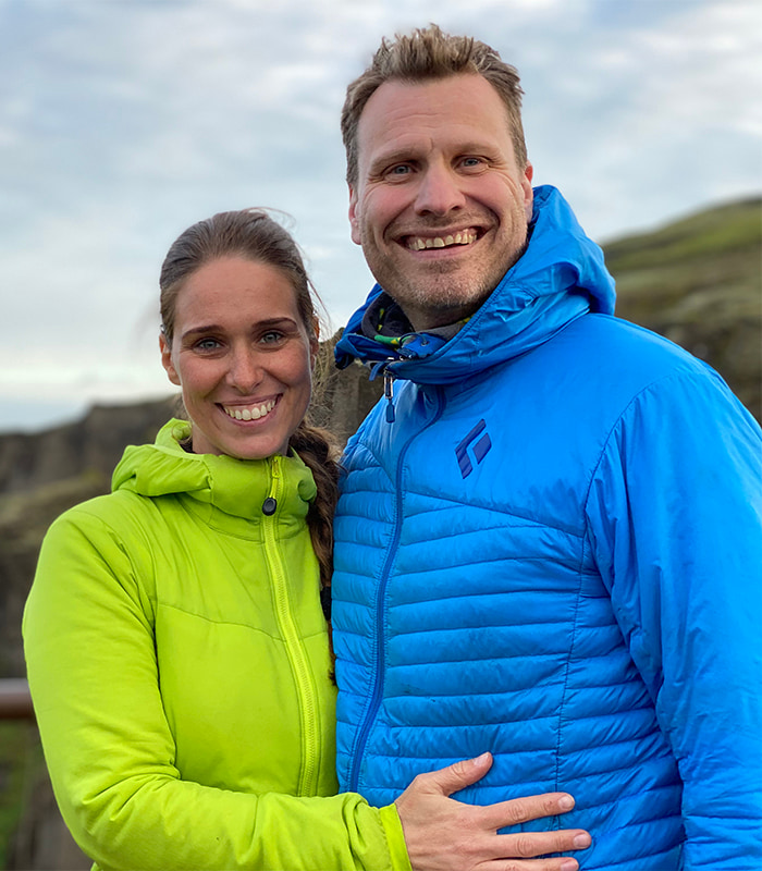 Founders of Luxury Adventures standing near the edge of Fjaðrárgljúfur canyon surrounded by dramatic cliffs and lush green landscape
