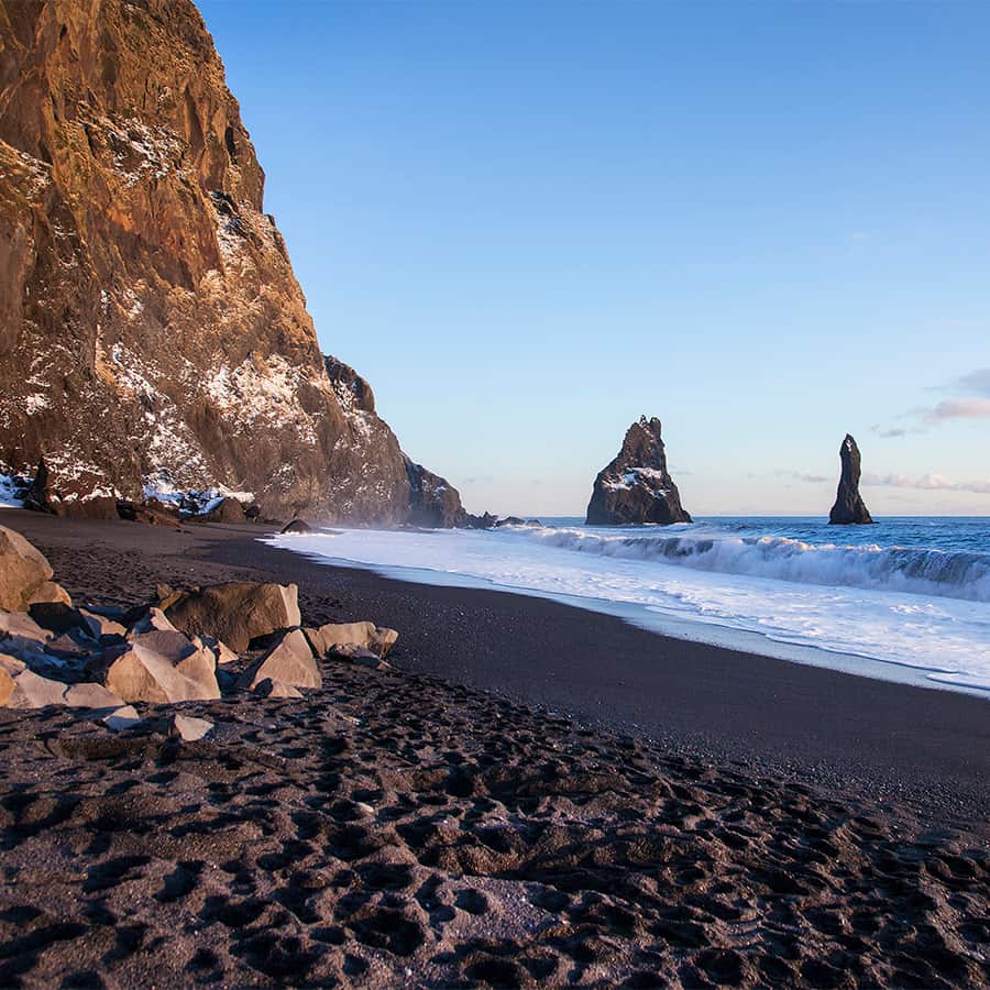 Black sand beach at Reynisfjara in South Iceland featuring dramatic coastal scenery and iconic basalt formations near Vík í Mýrdal