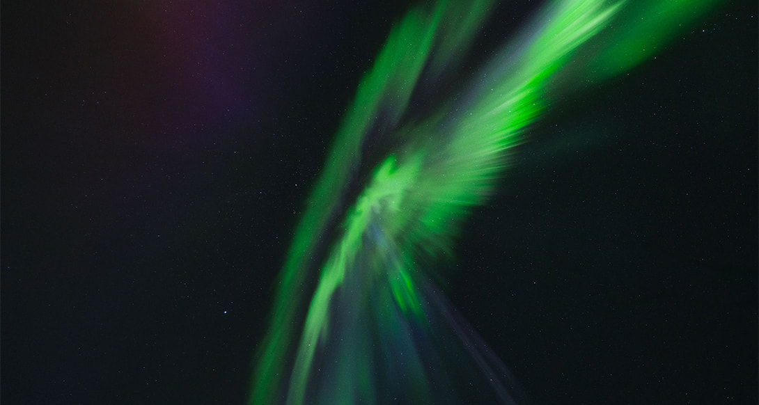 Vibrant northern lights swirling across the Arctic sky above snowy landscapes creating a breathtaking and magical winter night experience
