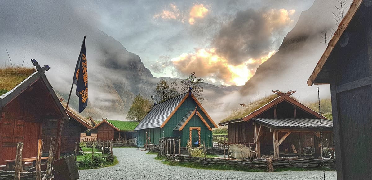 Traditional Viking village in Gudvangen Norway with wooden buildings and costumed figures offering an immersive cultural and historical experience