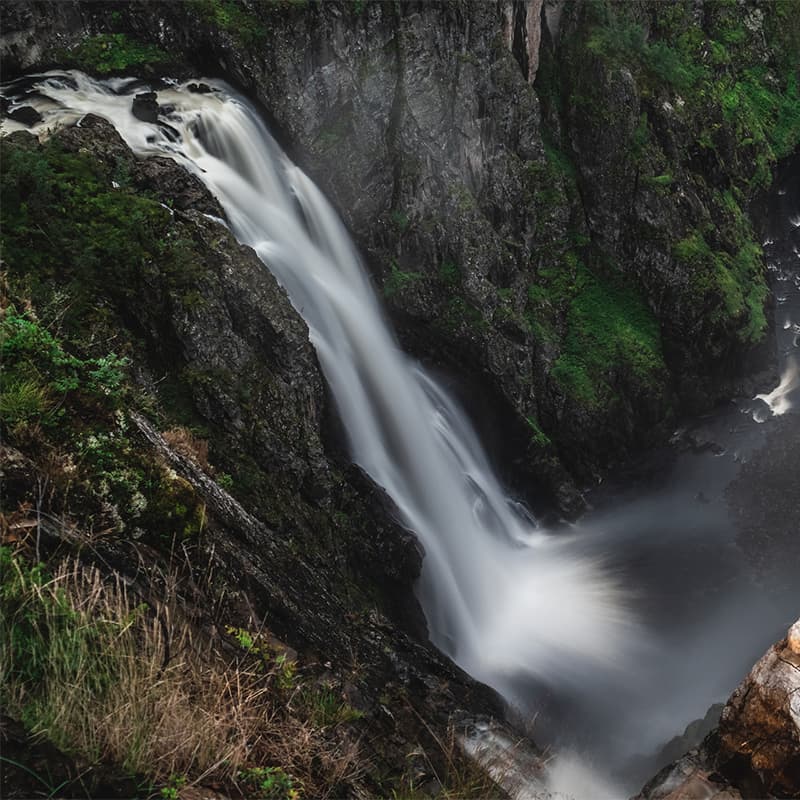 Vøringsfossen waterfall in Norway plunging between steep cliffs, showcasing dramatic natural power and scenic beauty in a mountainous landscape