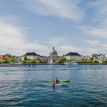 Kayaking in Copenhagen harbor Denmark with calm waters modern architecture and a relaxed urban coastal vibe